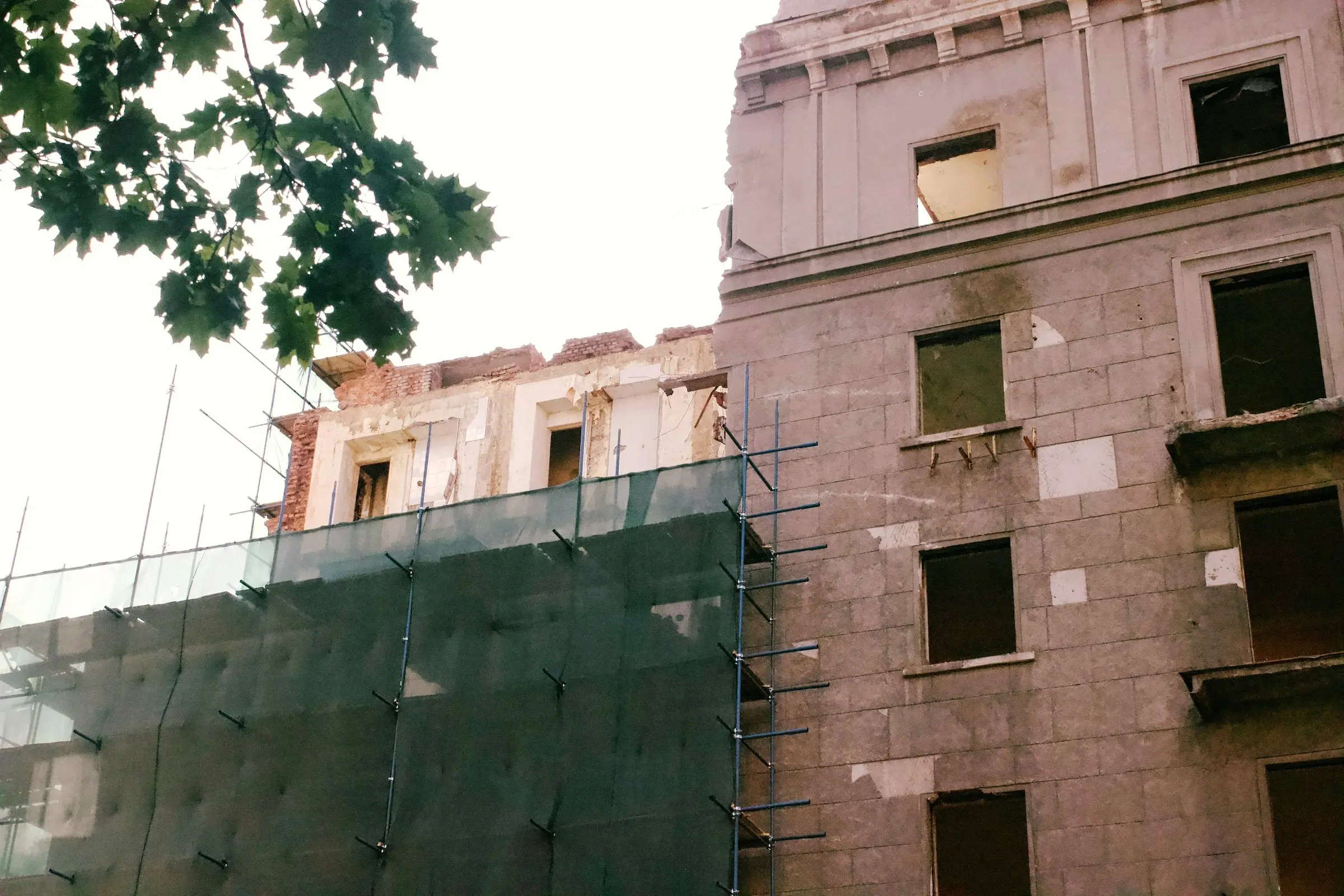 Edificio en rehabilitación protegido con malla durante los trabajos